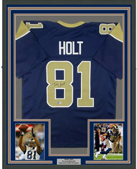 Framed Autographed/Signed Torry Holt 35x39 St. Louis Dark Blue Football Jersey Beckett BAS COA