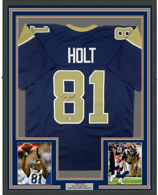 Framed Autographed/Signed Torry Holt 35x39 St. Louis Dark Blue Football Jersey Beckett BAS COA
