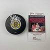 Autographed/Signed Patrice Bergeron Boston Bruins Logo Hockey Puck JSA COA